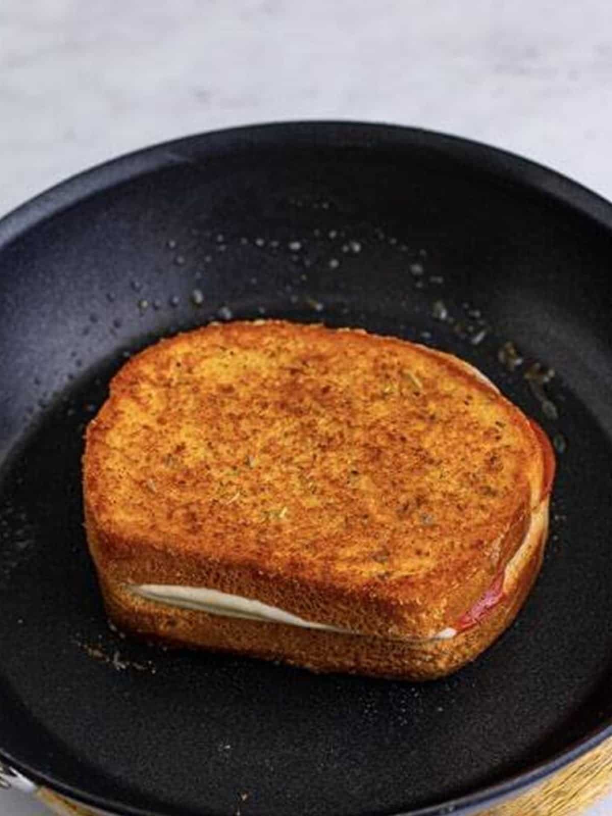 Golden grilled Pizza Sandwich cooked in the skillet.