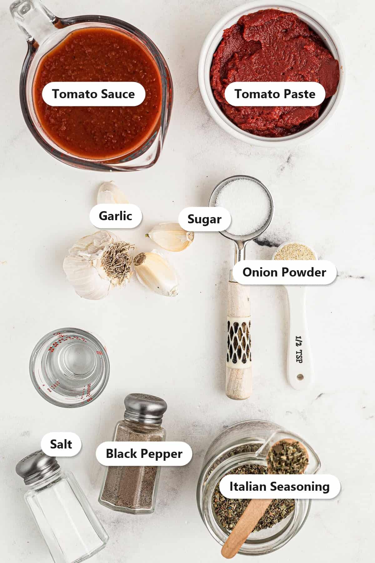 Labeled ingredients to make pizza sauce including tomato sauce, tomato paste, garlic, sugar, onion powder, salt, black pepper, and Italian seasoning.