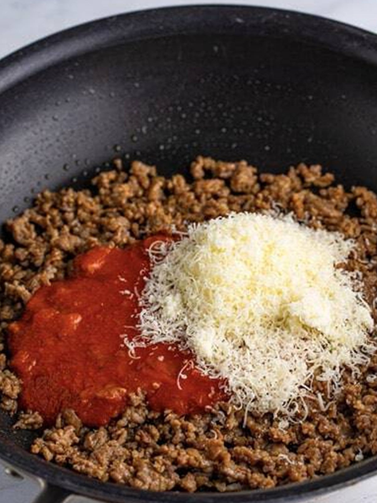 Browned Italian sausage simmered with pizza sauce and parmesan for the pizza sliders filling.