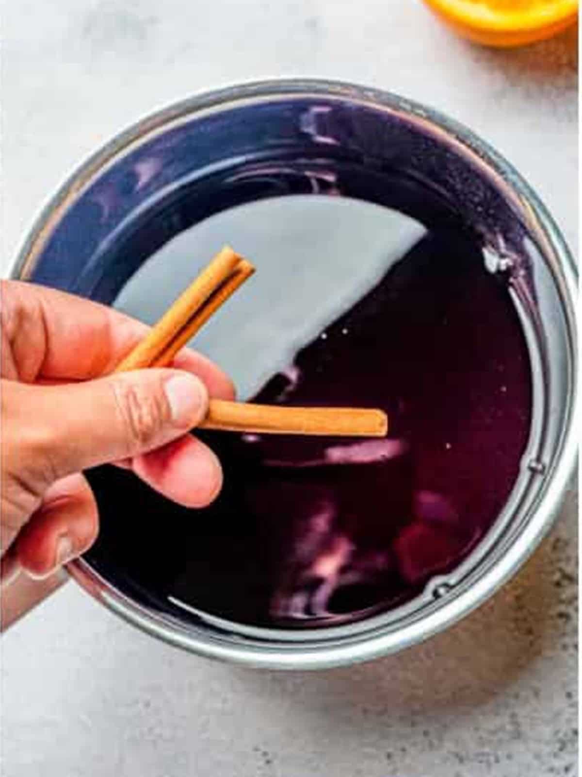 Cinnamon sticks added to the simmering red wine poaching liquid.