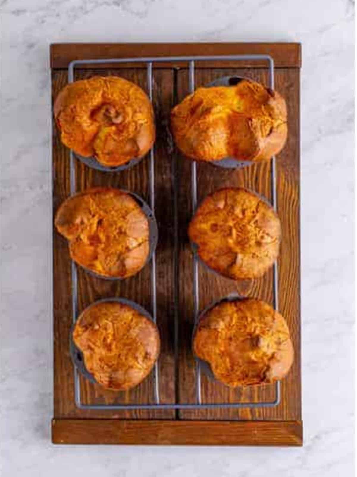Golden baked popovers puffed up in the popover pan.