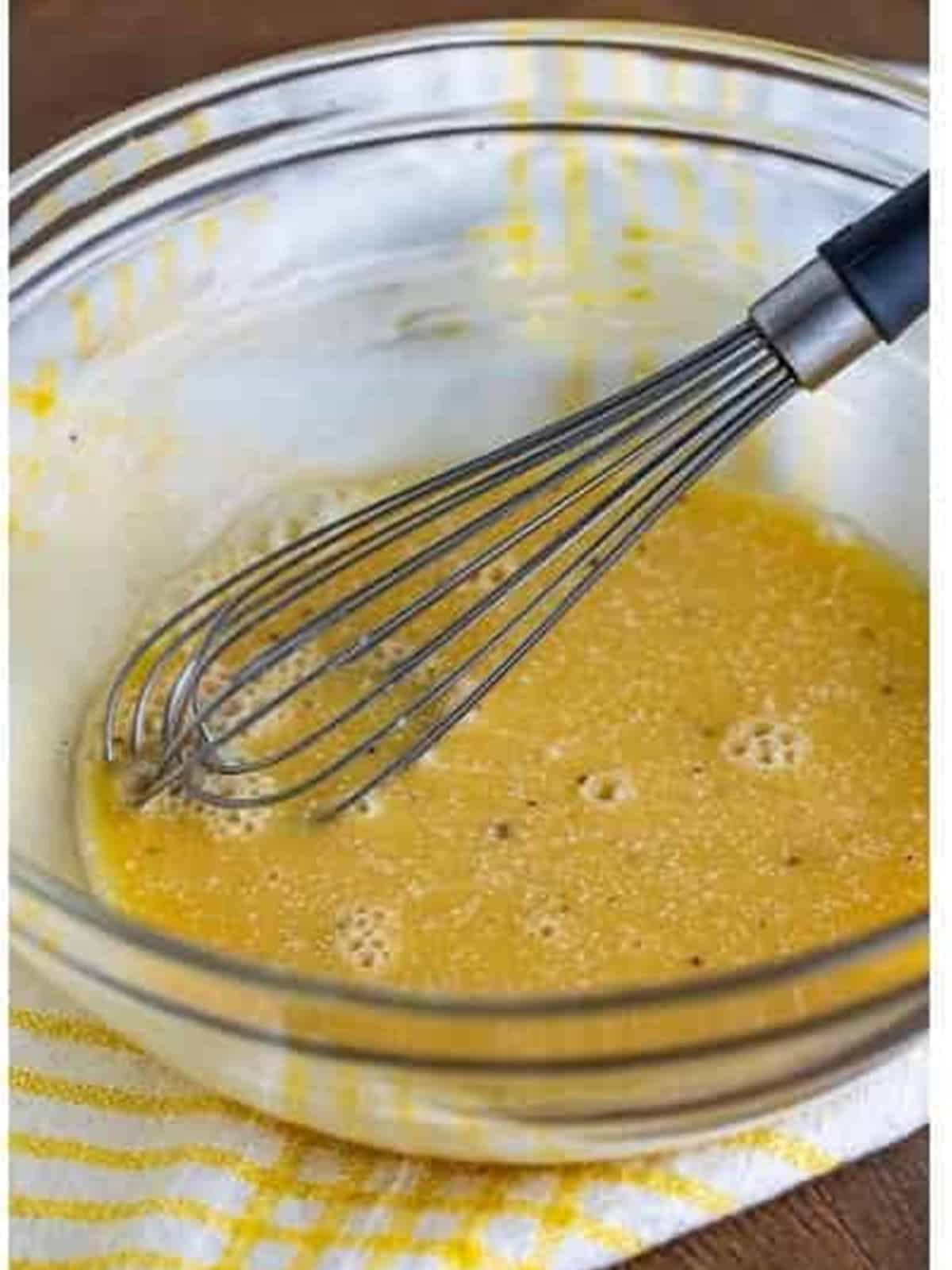 The poppy seed dressing base whisked together until smooth in a glass bowl.