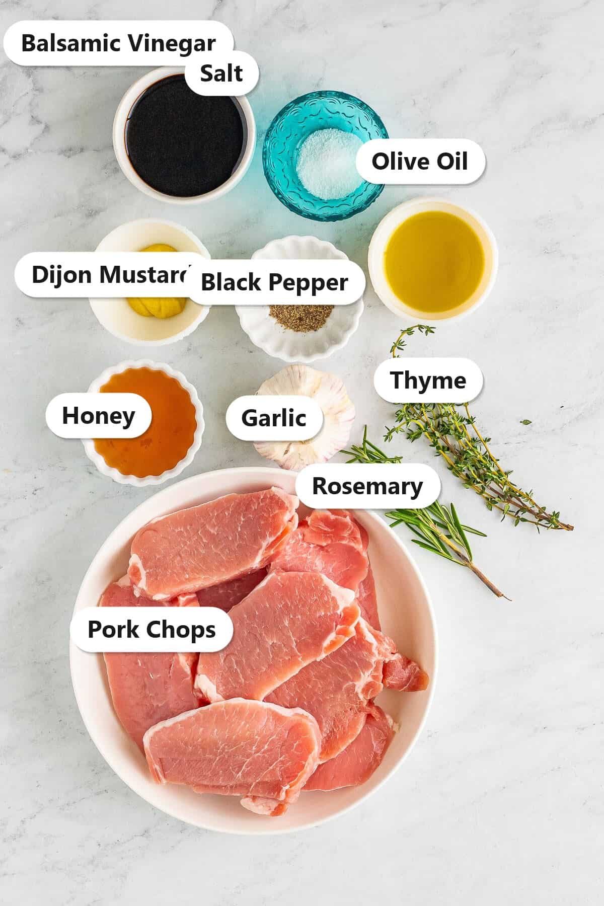 Labeled ingredients for pork chop marinade including balsamic vinegar, olive oil, honey, dijon, garlic, herbs, and pork chops.