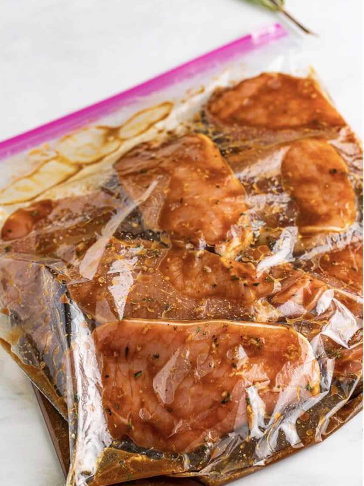 Pork chops marinating in the balsamic marinade in a sealed bag in the fridge.