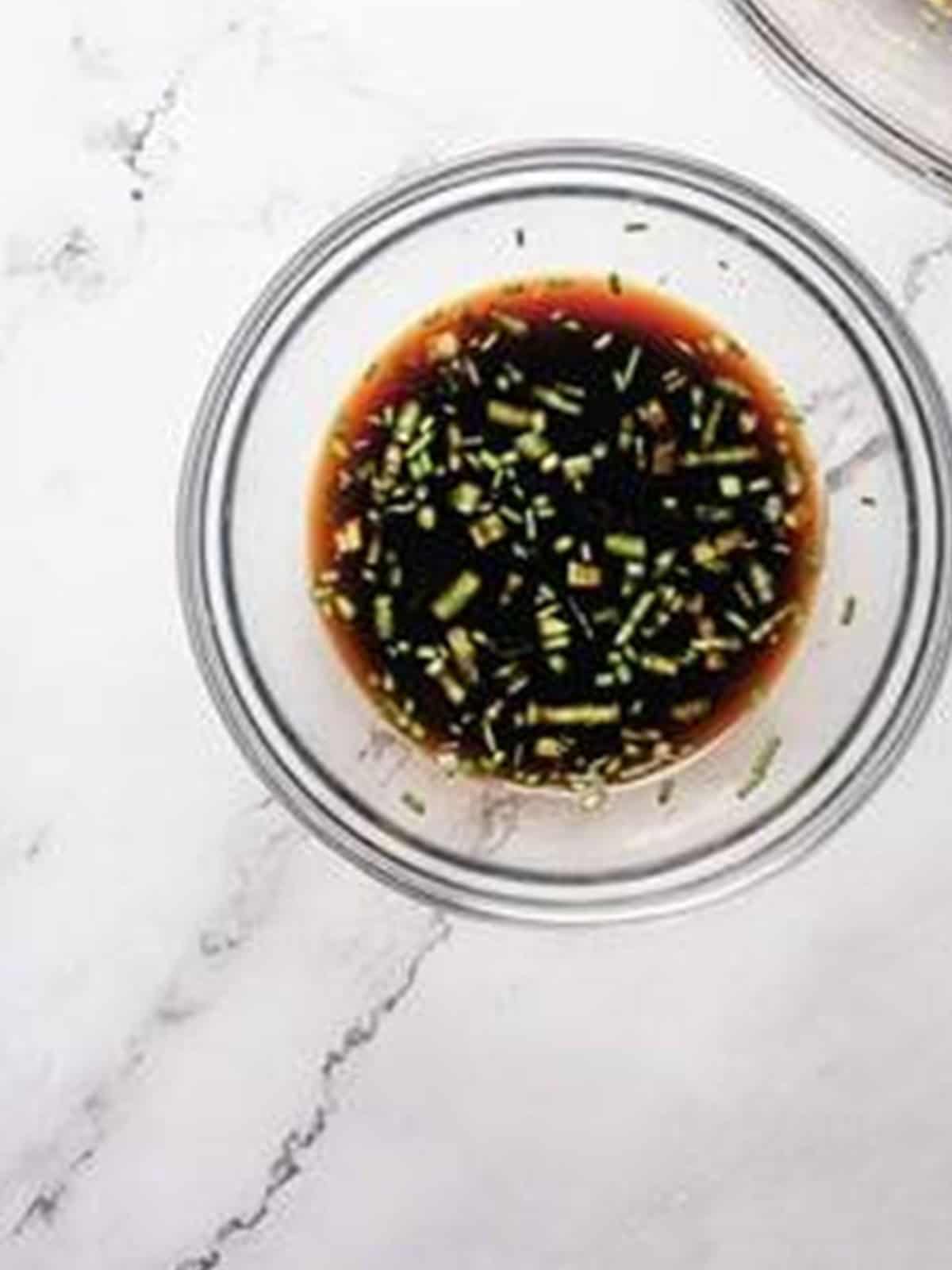 Whisking together a soy and vinegar dipping sauce for pork dumplings.