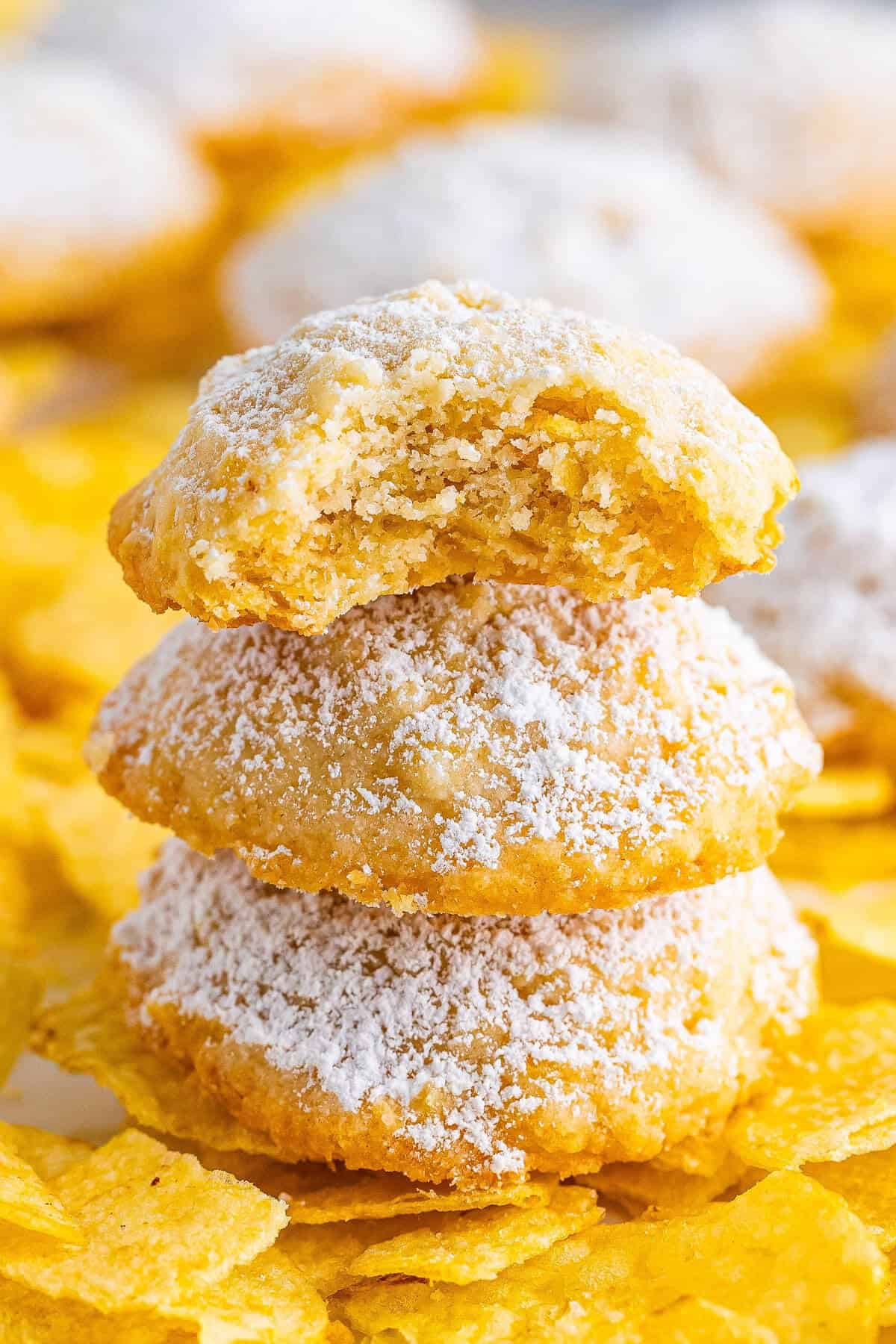 A stack of light and buttery potato chip cookies dusted with powdered sugar.