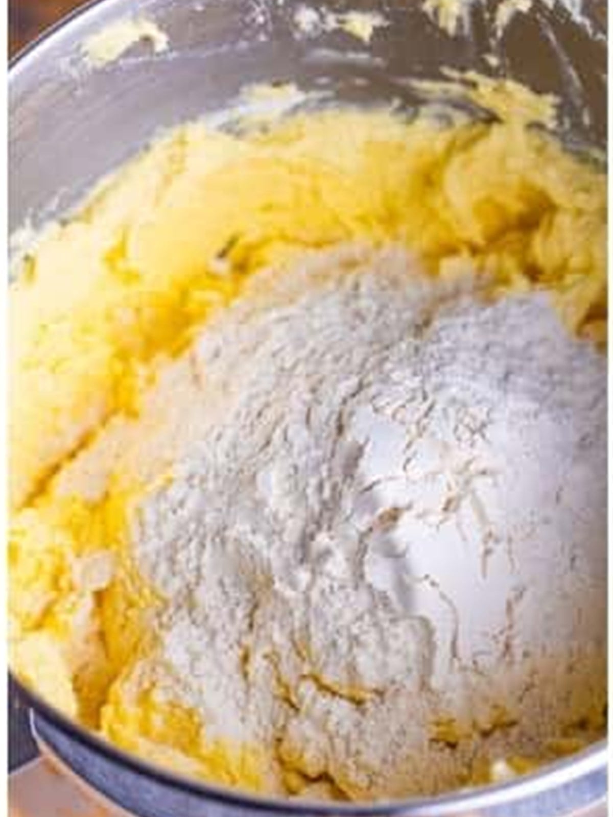 Adding flour to pound cake batter in a mixer bowl