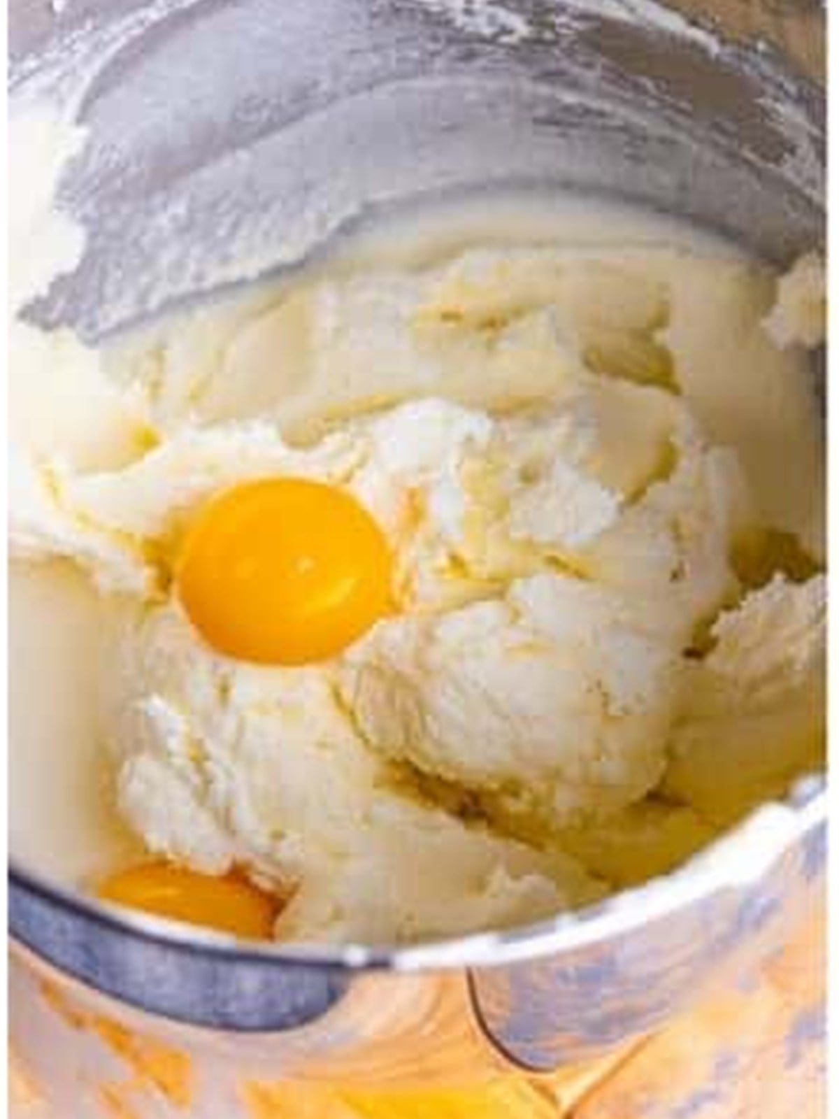 Adding egg yolks to creamed butter and sugar for pound cake