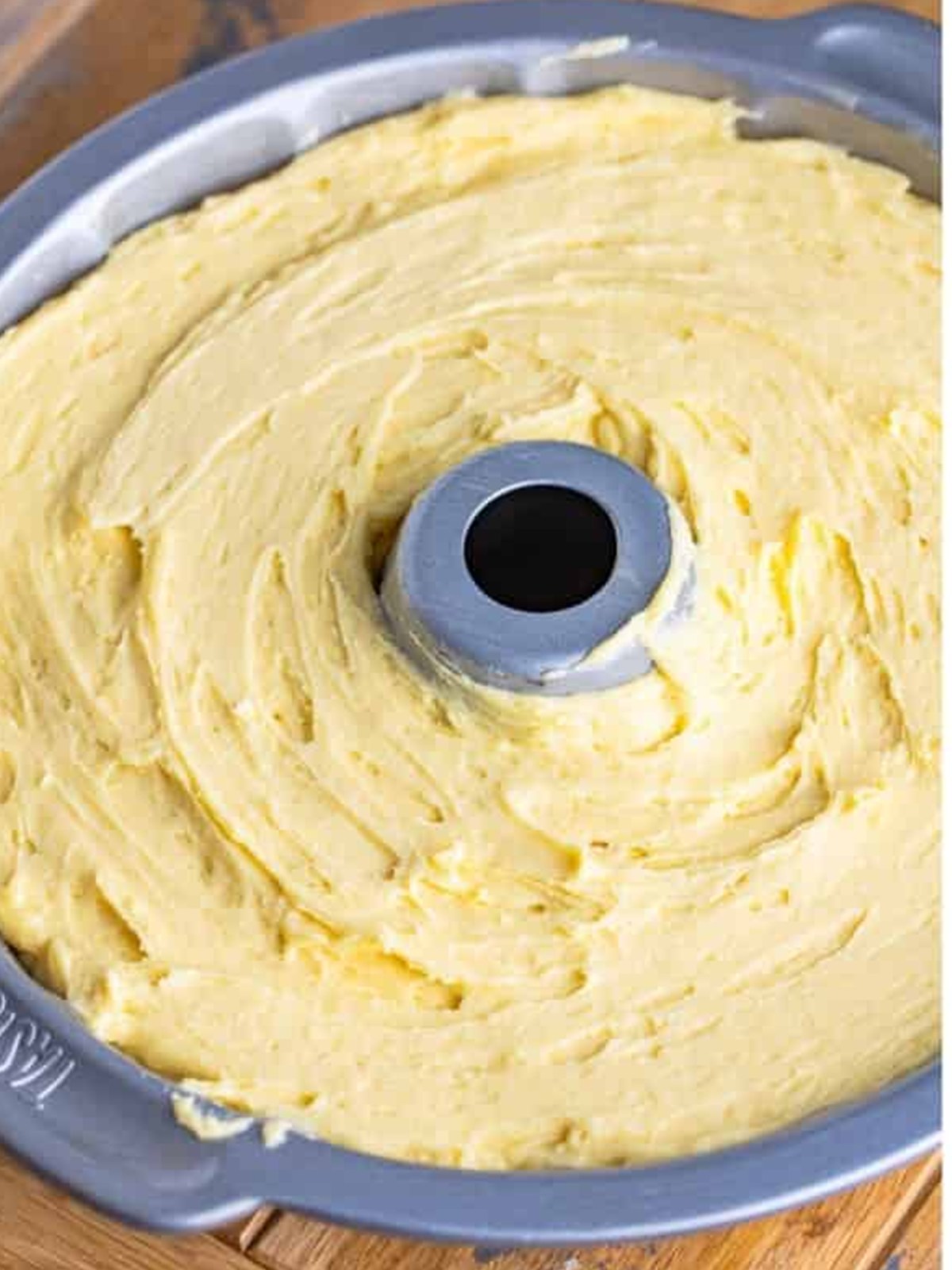 Pound cake batter spread evenly in a greased bundt pan