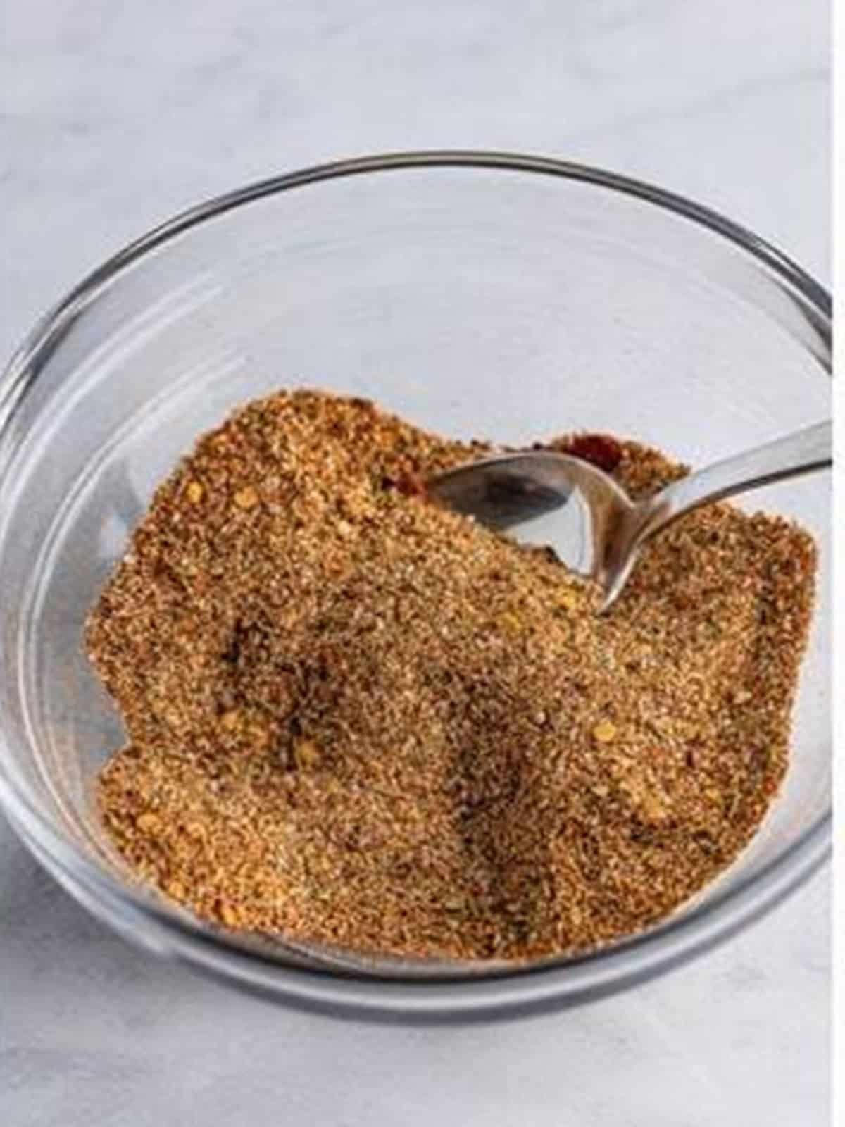 Smoked paprika spice rub mixed in a glass bowl for pulled pork.