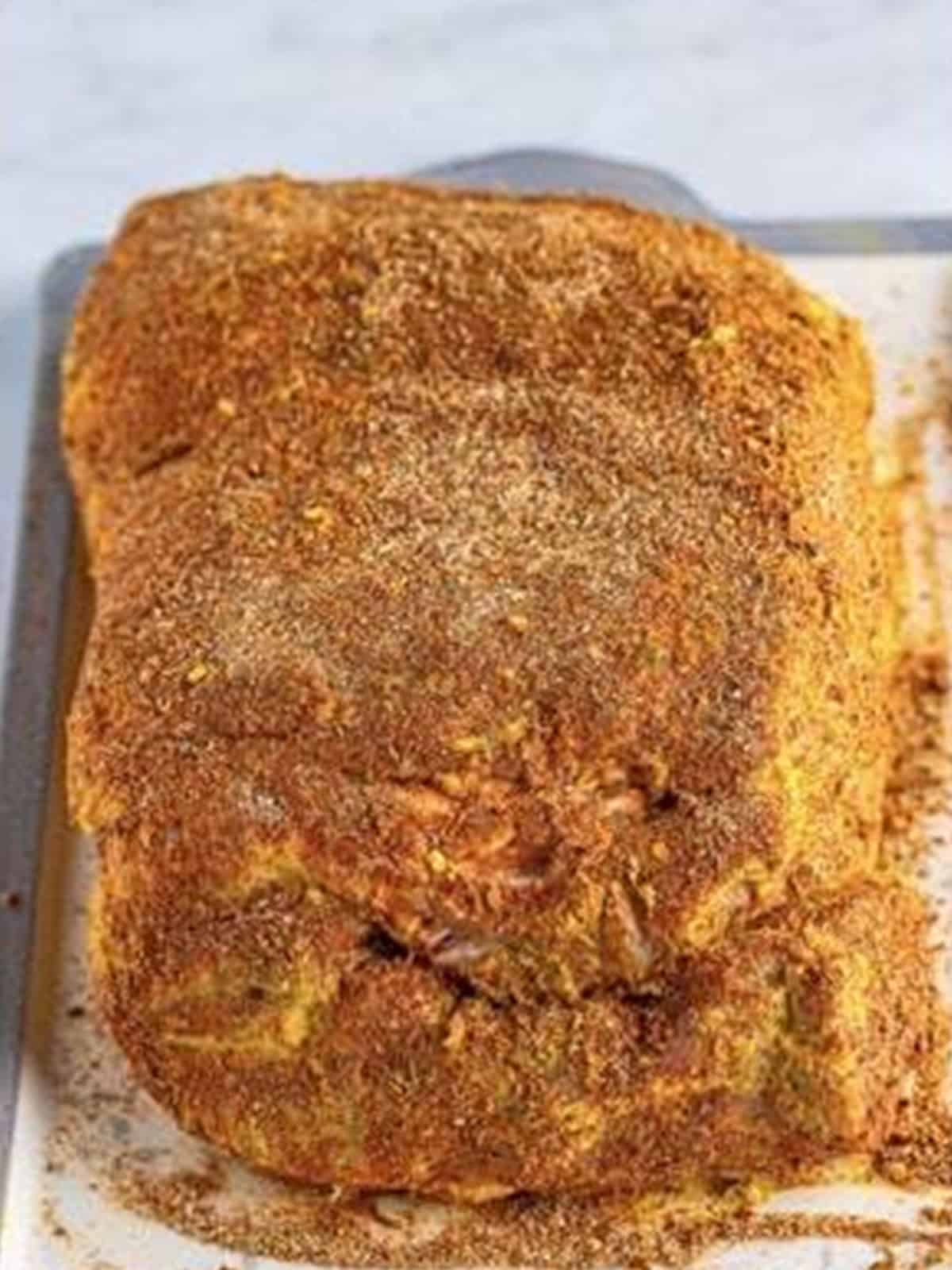 A pork shoulder rubbed all over with the spice mix.
