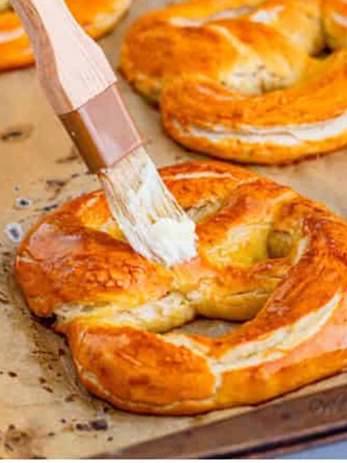 Baked golden brown soft pretzels brushed with melted butter.