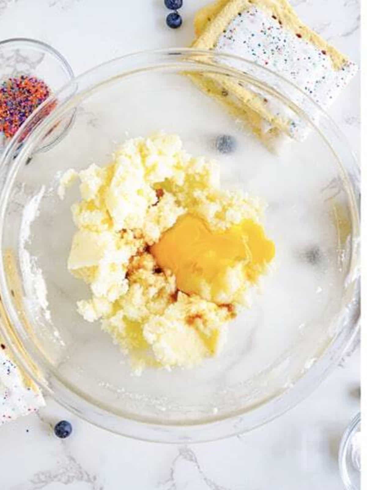 Butter, sugar, egg, and vanilla in a glass bowl for pop tart sugar cookie dough.