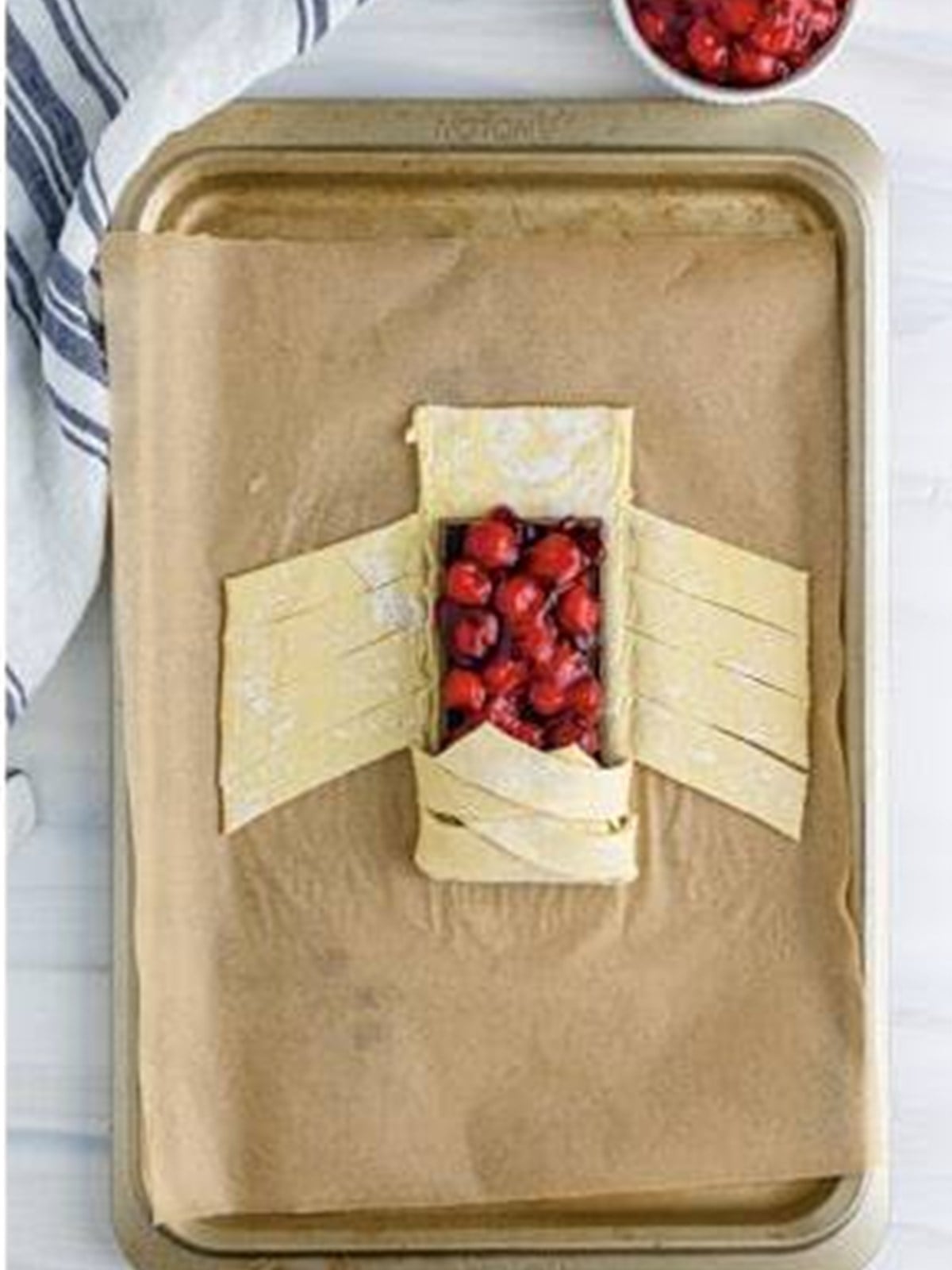The bottom flap of puff pastry folded over the filling.