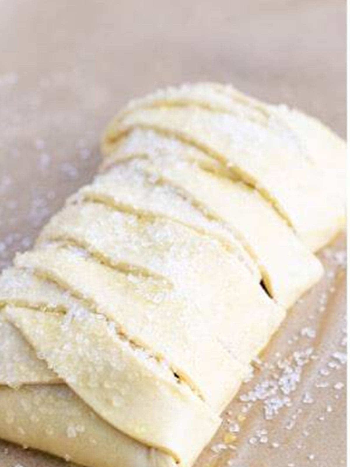 Decorators sugar sprinkled over the puff pastry braid.