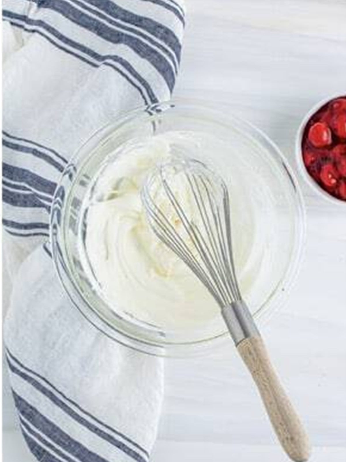 Whipped cream beaten in a glass bowl to serve with the pastry braid.