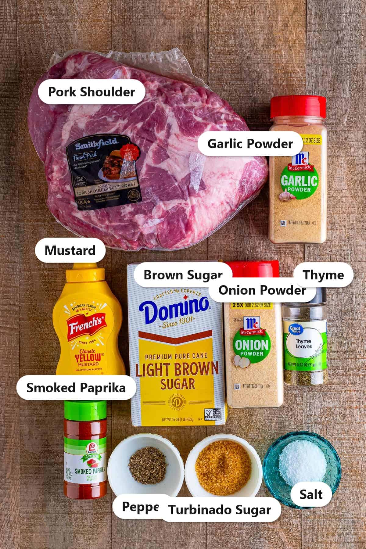 Labeled ingredients for pulled pork recipe including pork shoulder, mustard, brown sugar, turbinado sugar, smoked paprika, garlic powder, onion powder, thyme, salt, and pepper.