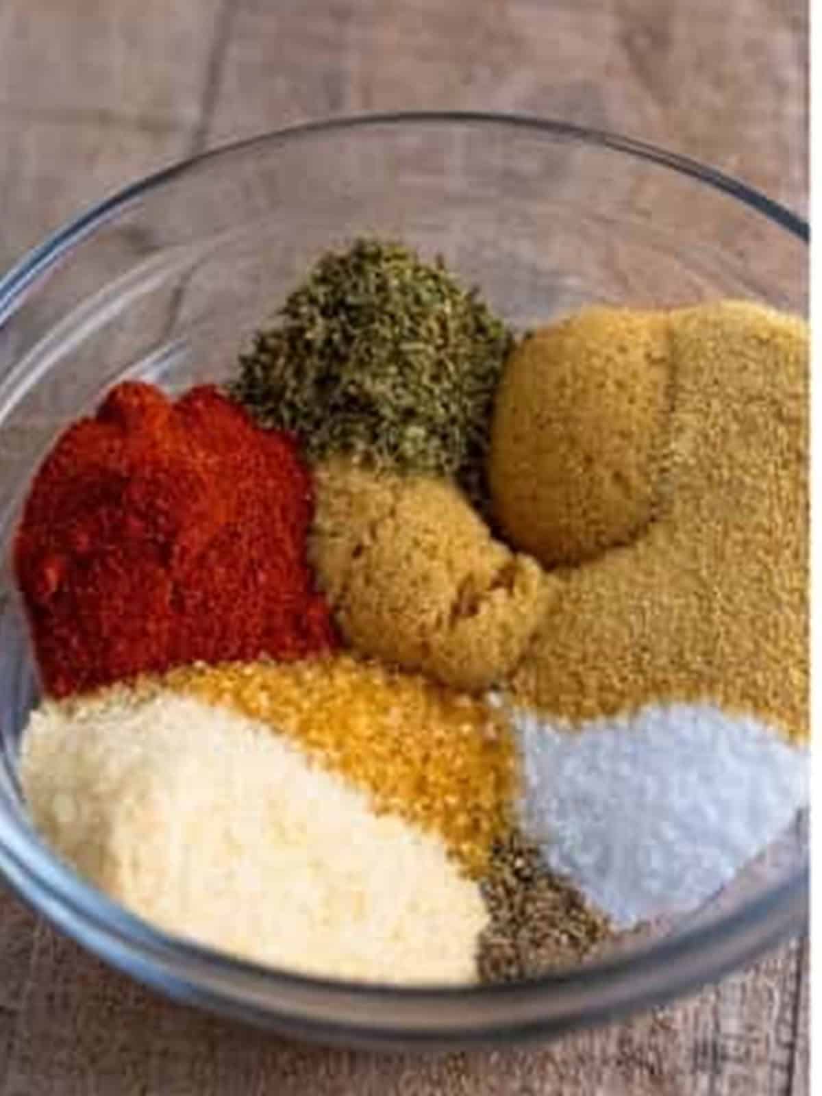 Brown sugar, paprika, garlic powder, onion powder, salt, pepper, and thyme in a bowl to make the pulled pork recipe spice rub.