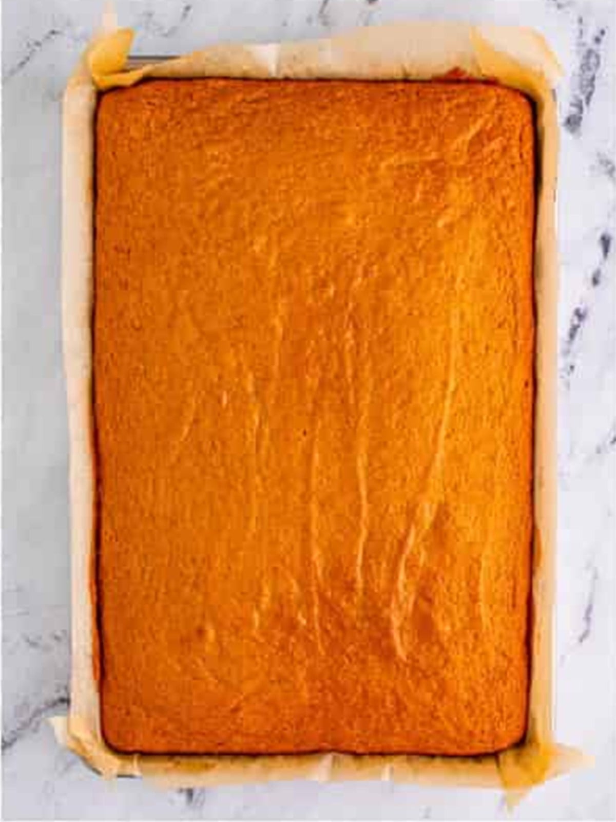 Freshly baked pumpkin bar cake in a pan.