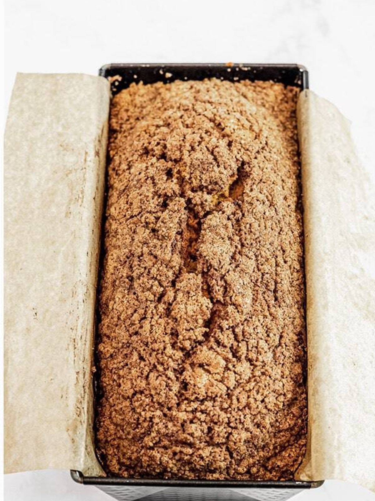 Baked pumpkin bread with streusel in a loaf pan