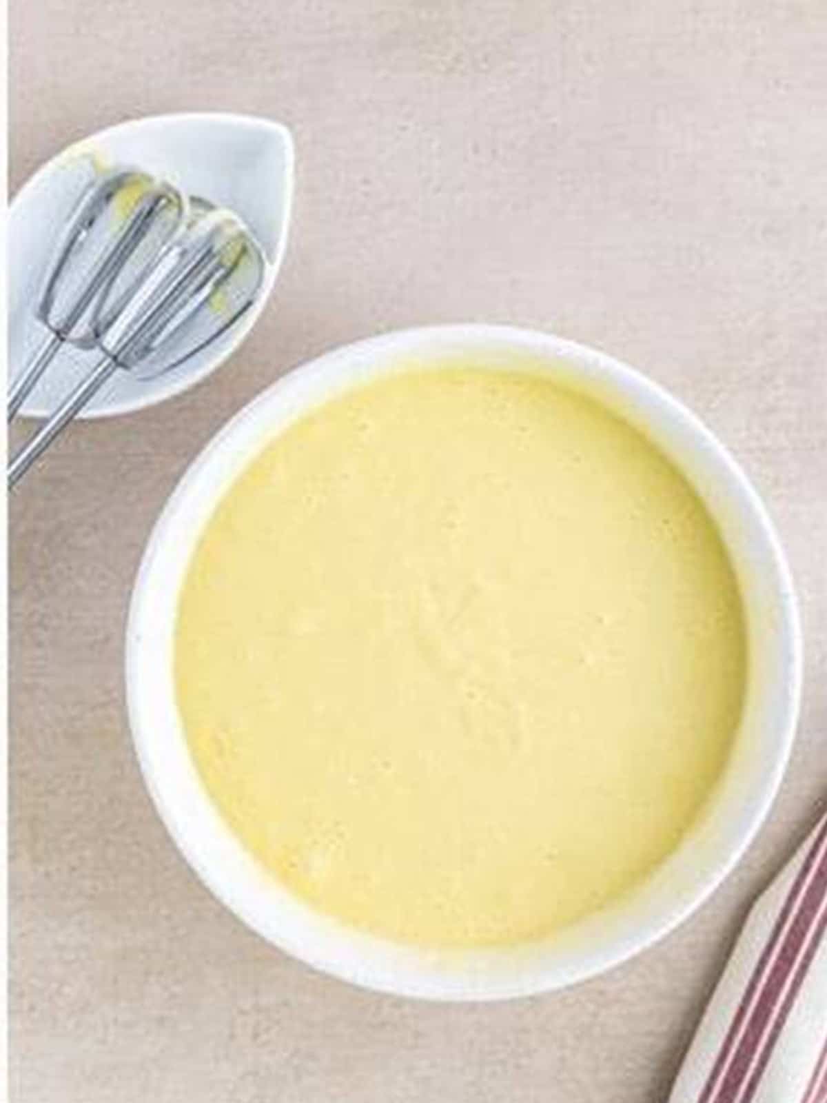 Almond cupcake batter mixed smooth in a bowl.