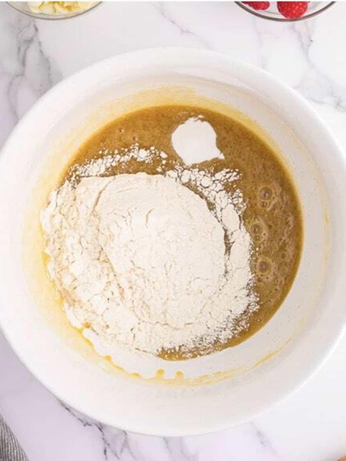 Flour and baking powder added to the blondie batter.