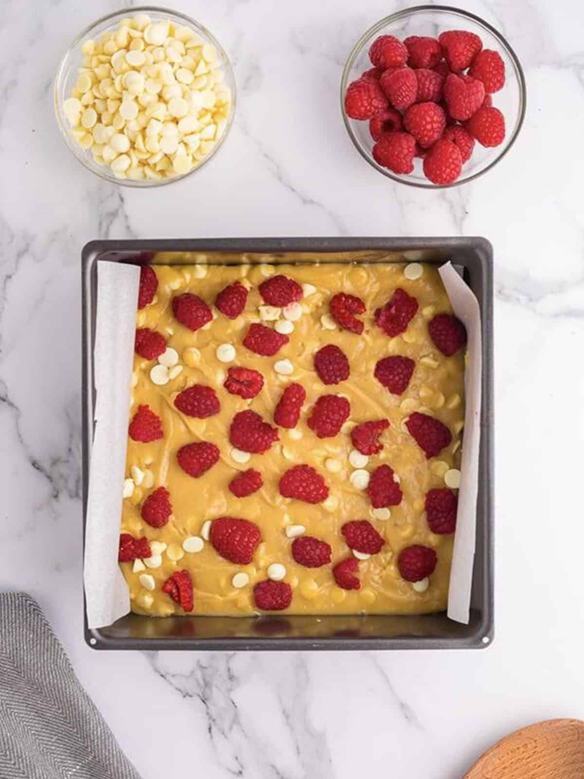 Fresh raspberries pressed into the blondie batter in a pan.