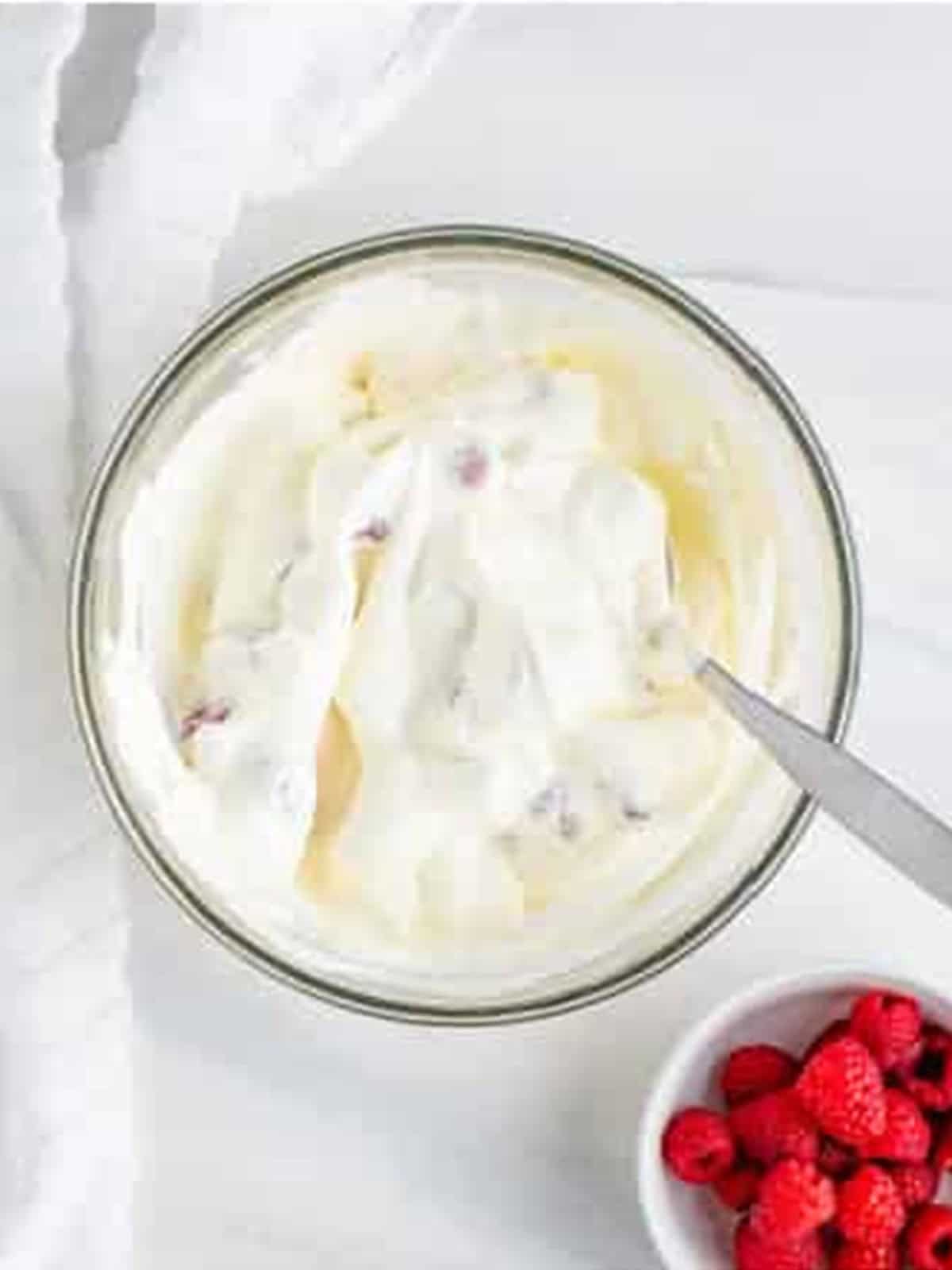 Fresh raspberries folded into whipped cream for Raspberry Icebox Cake.