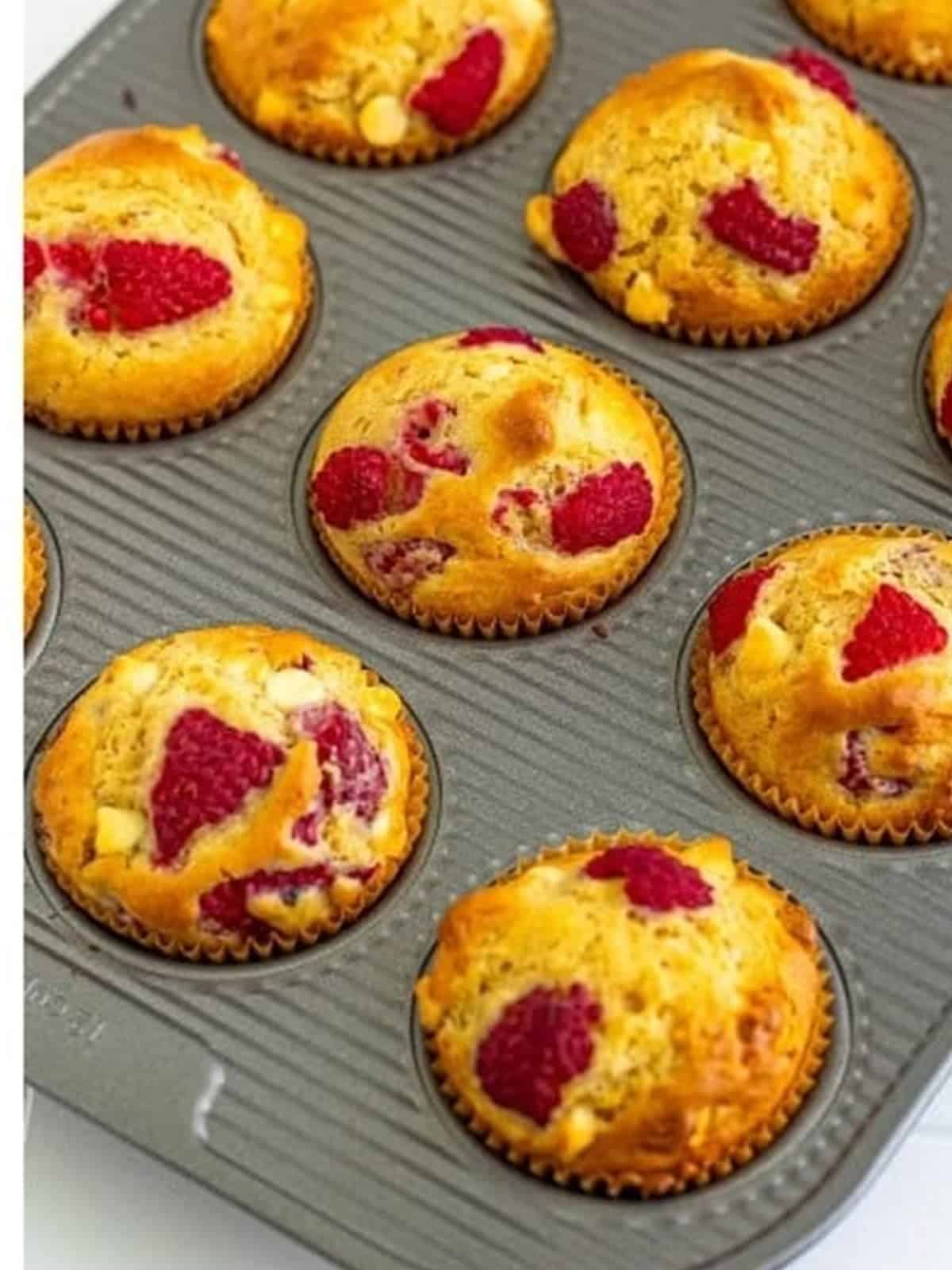 Baked white chocolate raspberry muffins in the muffin tin.