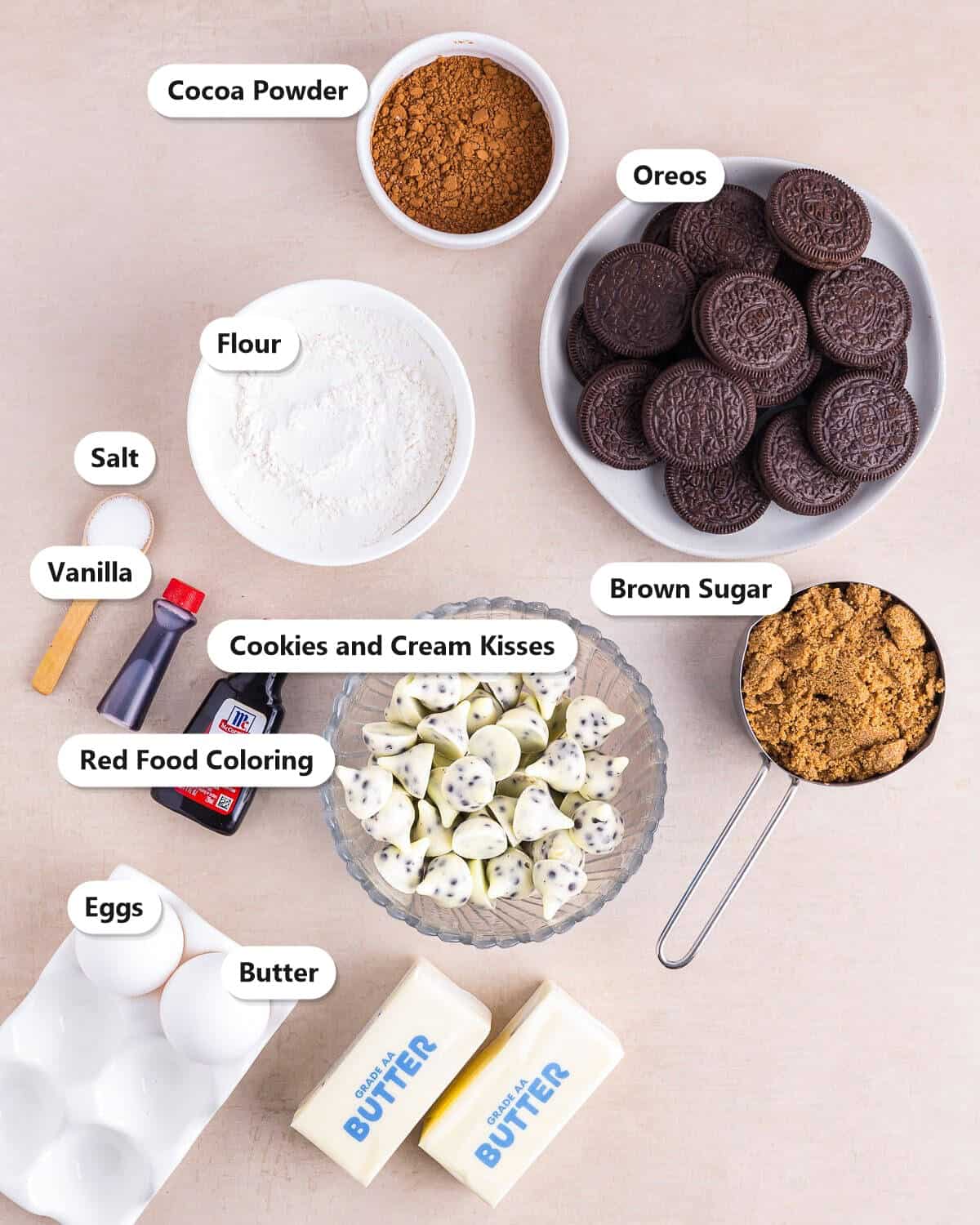 Cocoa powder, Oreos, flour, salt, vanilla, red food coloring, cookies and cream kisses, brown sugar, eggs, and butter labeled for Red Velvet Brownies.