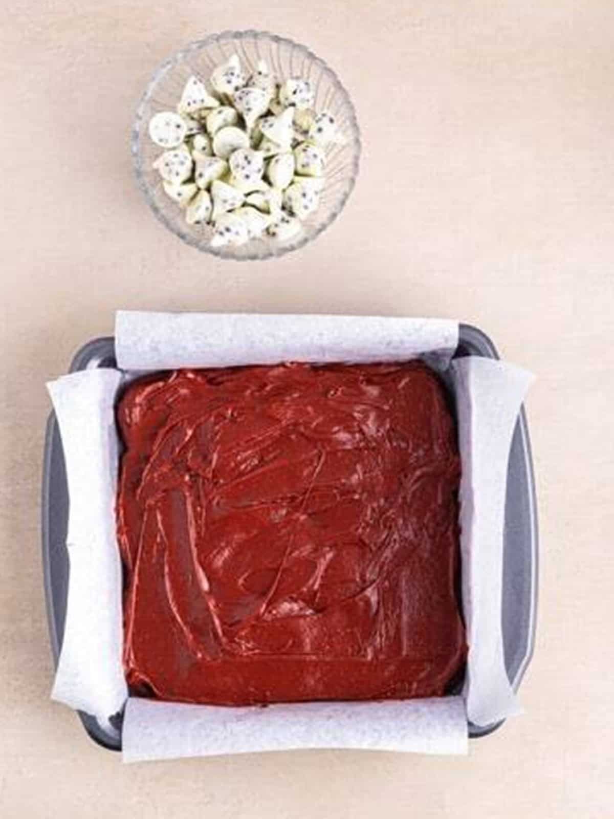 The remaining red velvet batter smoothed over the Oreo layer before baking.