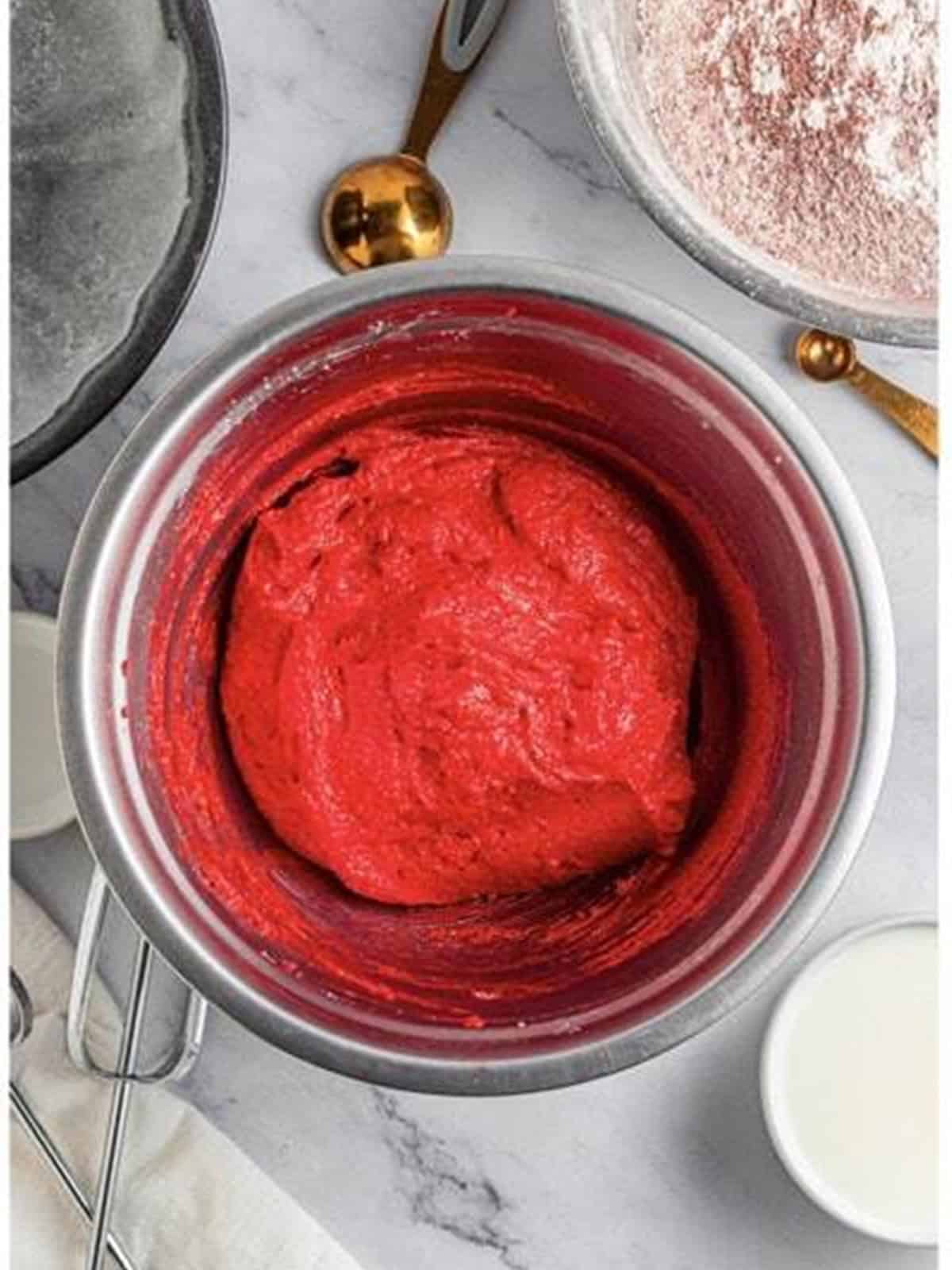 The red velvet cake batter mixed until smooth and vibrant red.