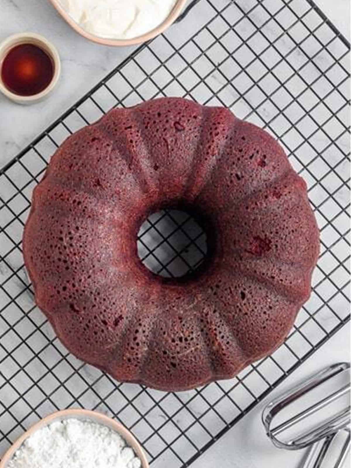 The baked red velvet bundt cake turned out onto a cooling rack.