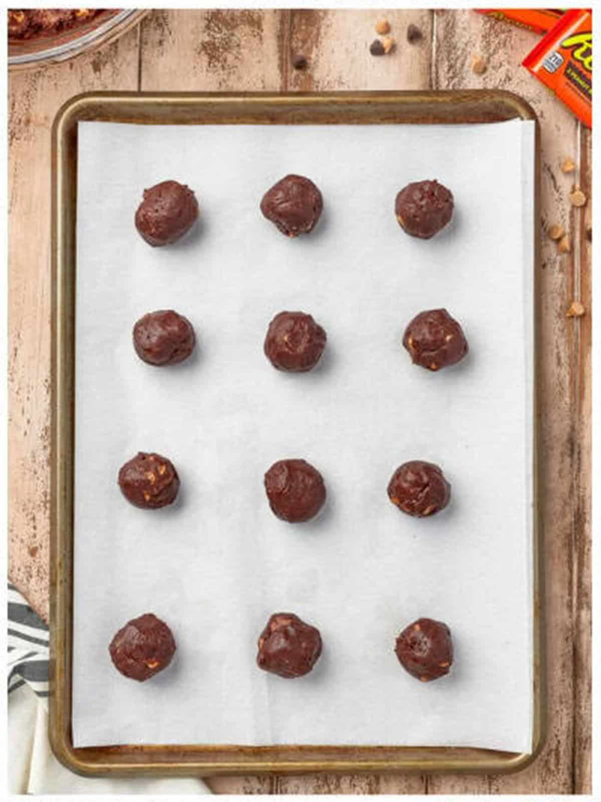 Dough balls on a baking sheet for Reeses cookies.