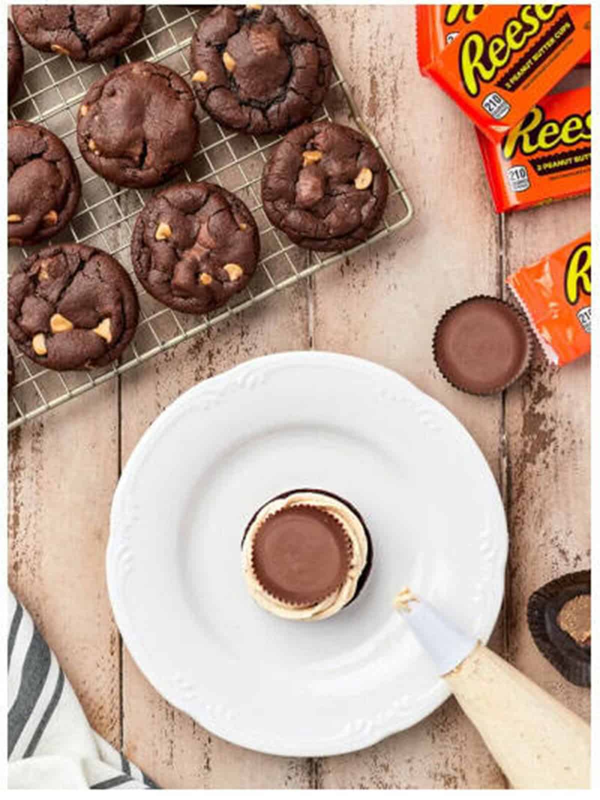 Piping peanut butter filling onto Reeses cookies.