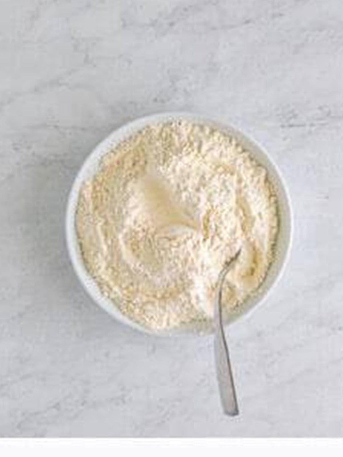 Dry ingredients whisked together in a white bowl for the cookie dough.