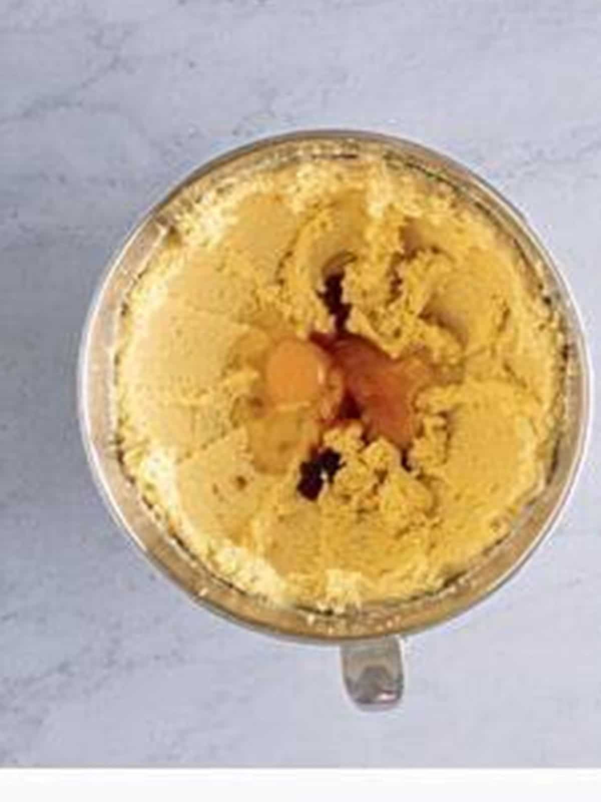 Eggs and vanilla added to the creamed butter mixture.
