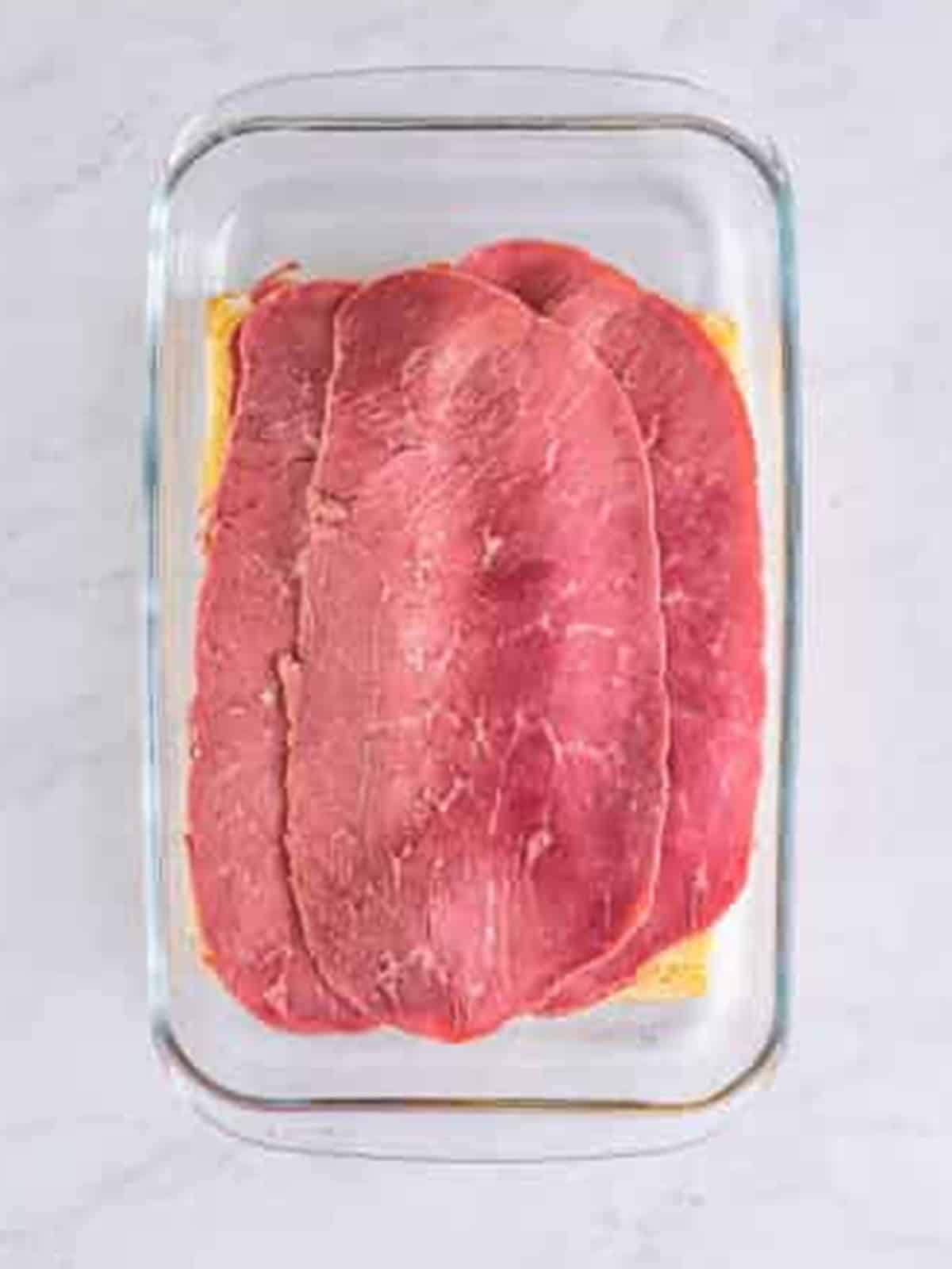 Corned beef layered over swiss cheese on Hawaiian rolls.