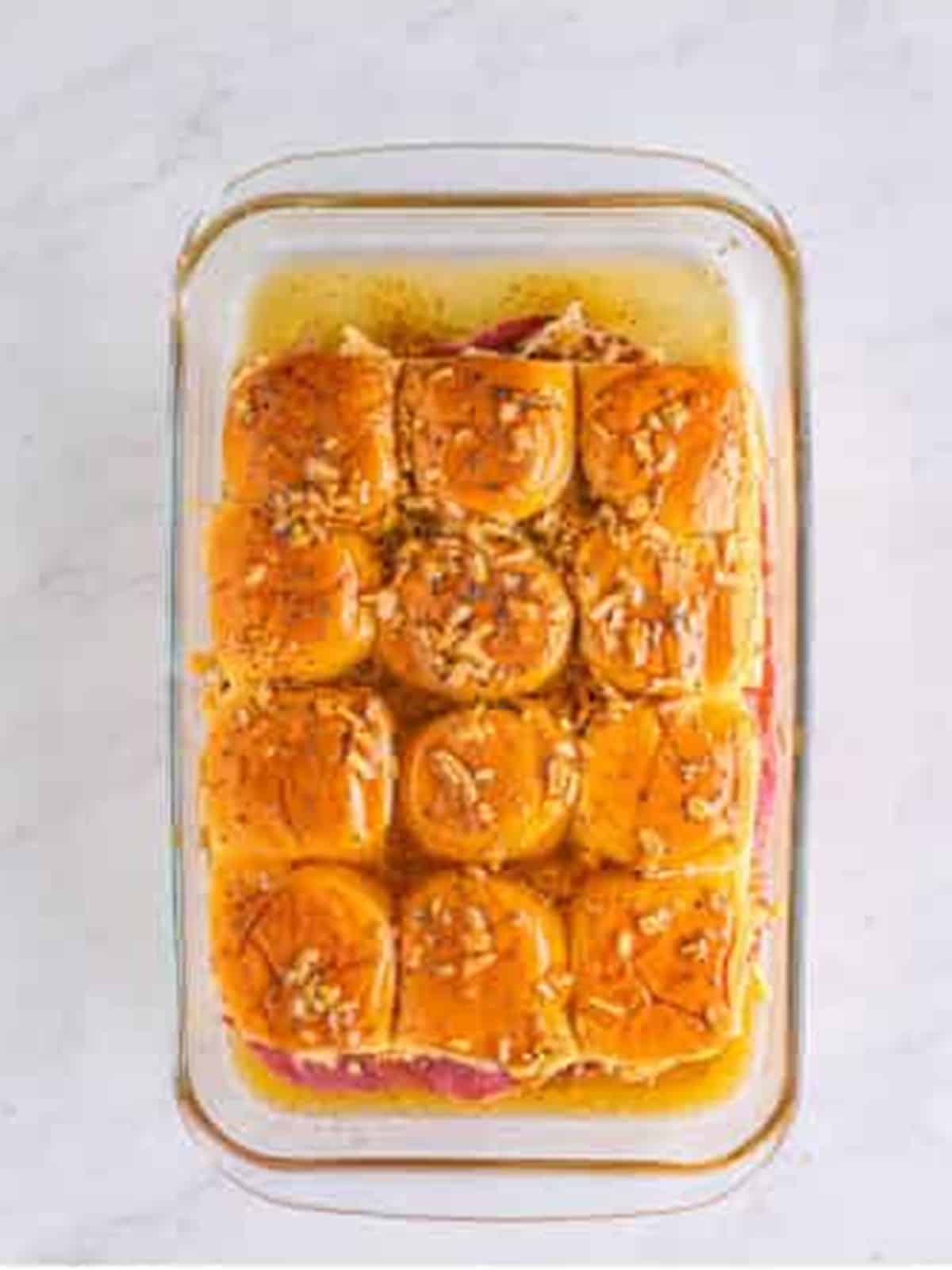 Golden baked reuben sliders in a baking dish.