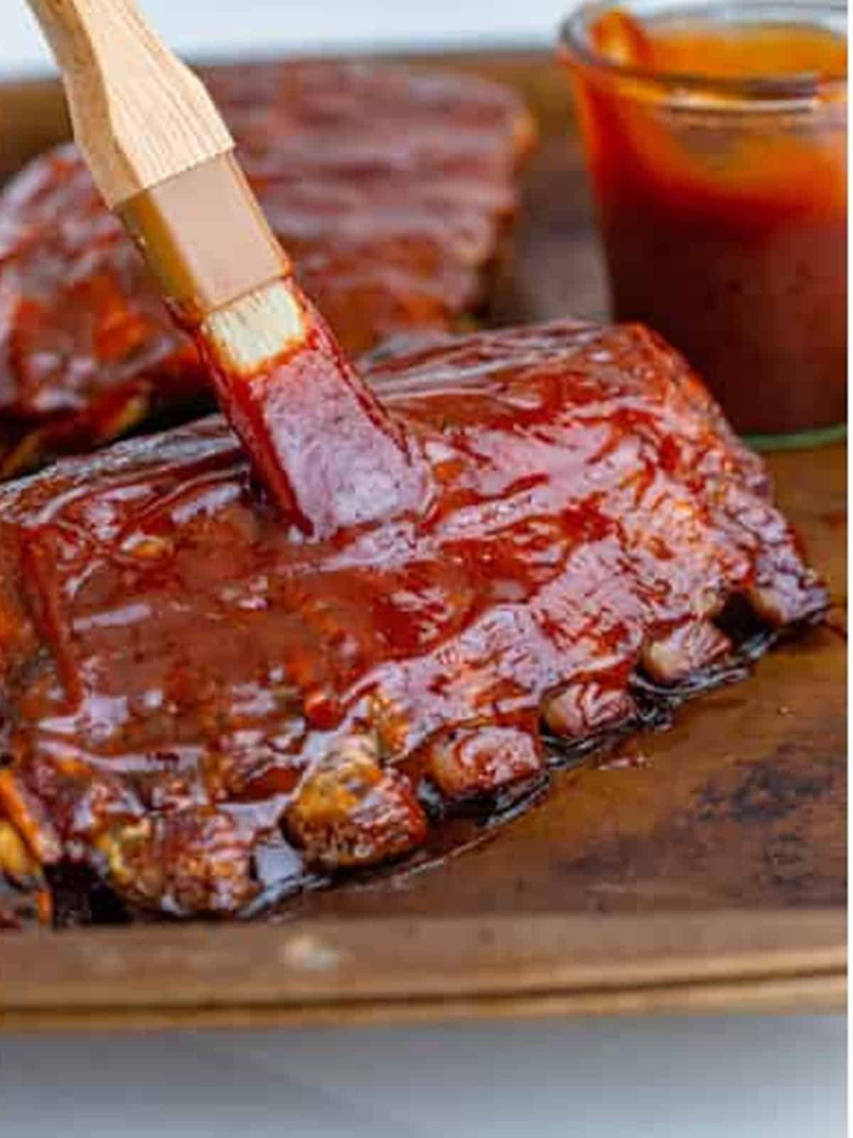 BBQ sauce brushed over slow cooker ribs before broiling.