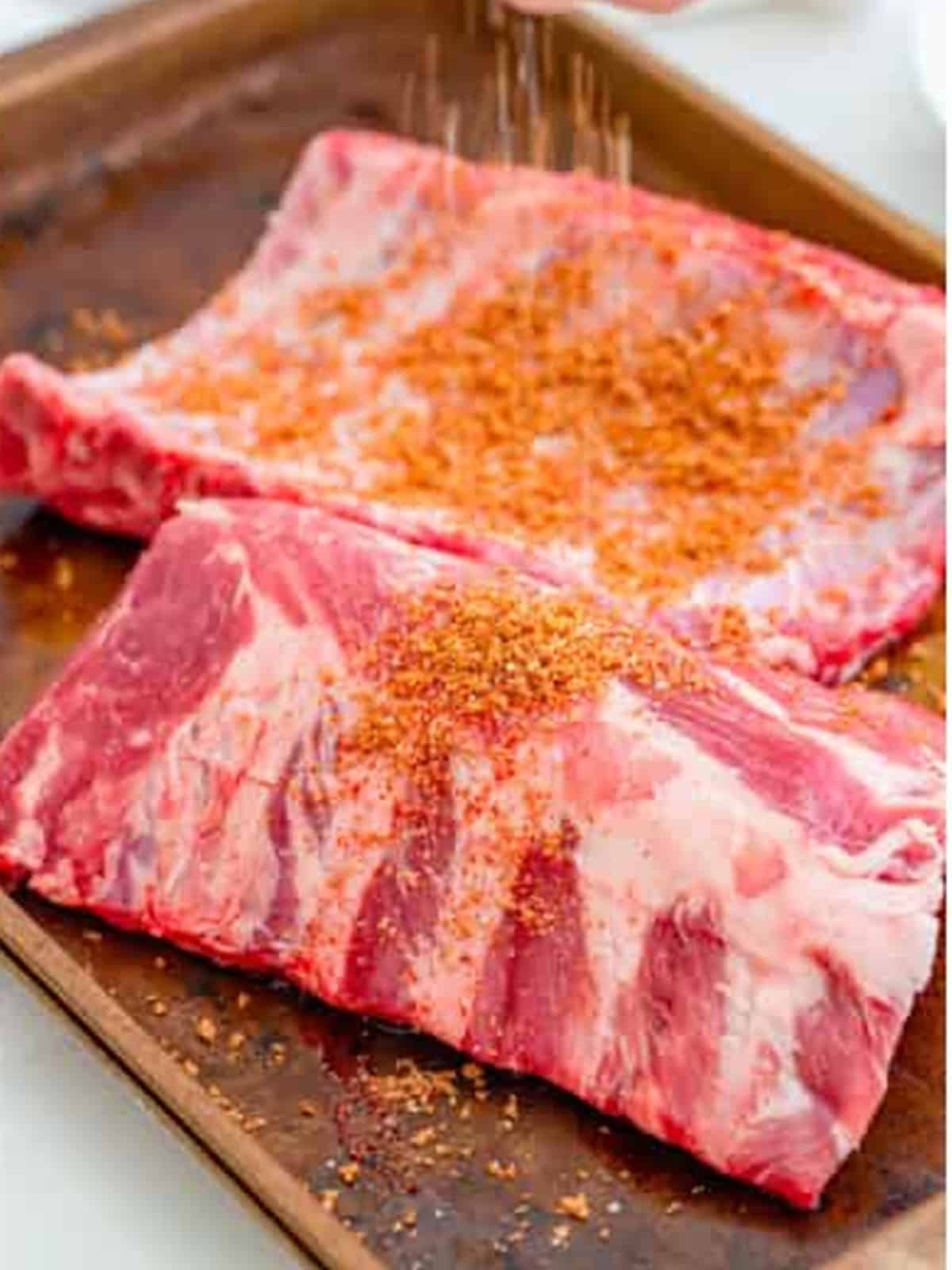 Spice rub massaged all over a rack of baby back ribs.
