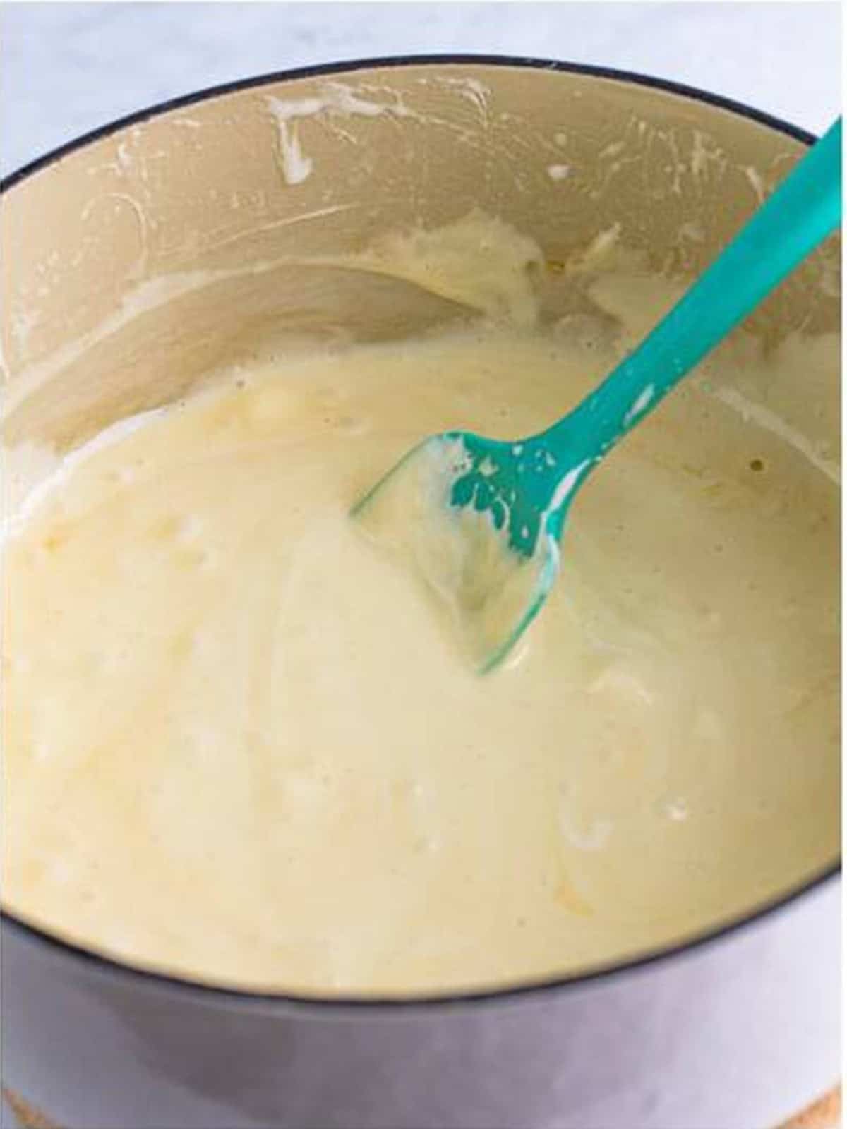 Marshmallows melted smooth with vanilla and salt for Rice Krispie Treats.