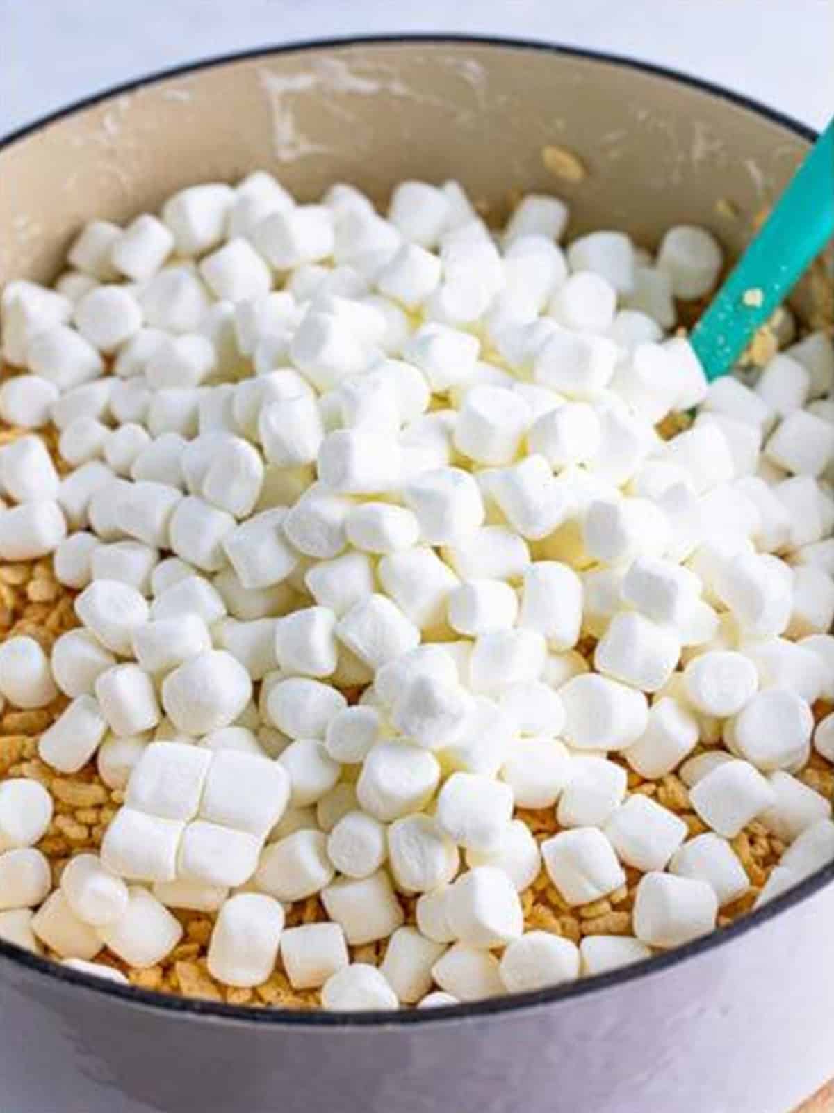 Rice krispies cereal and reserved marshmallows folded into the marshmallow mixture.