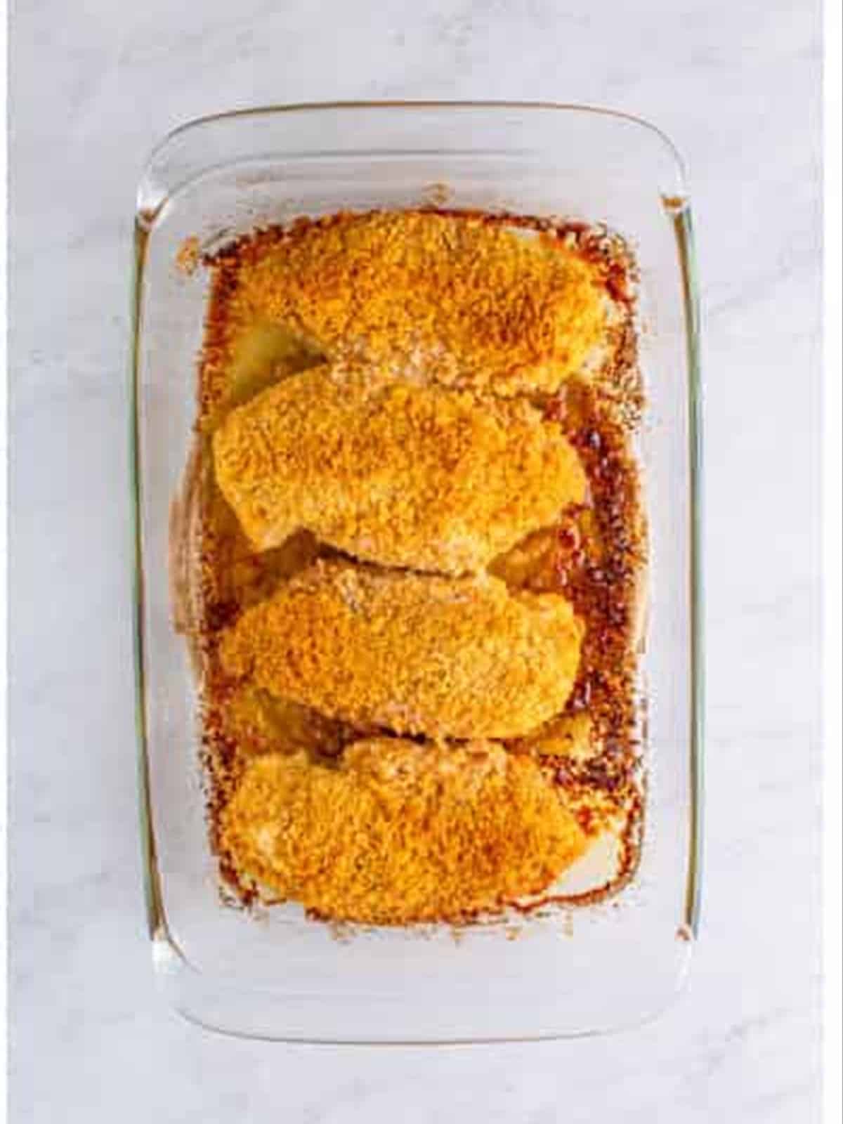Baked golden Ritz cracker chicken in a dish.