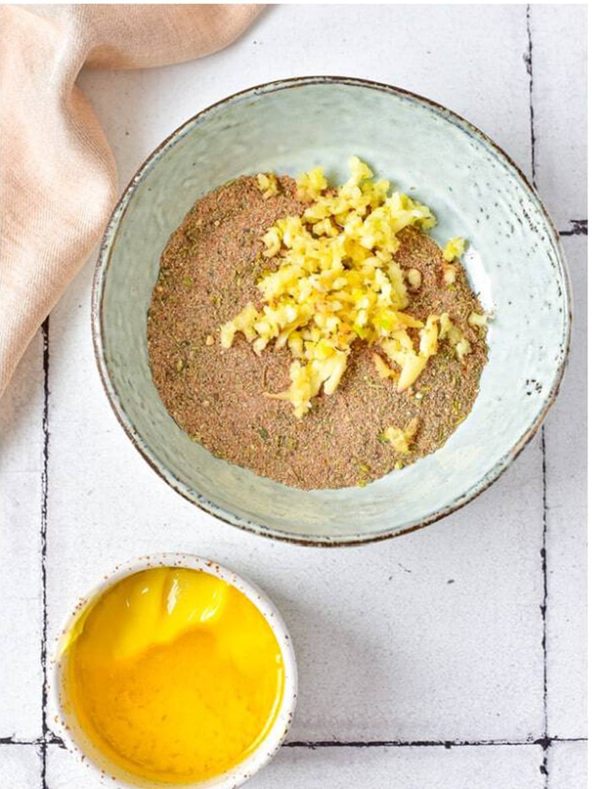 Minced garlic and melted butter stirred into the seasonings to make a paste for roast chicken.