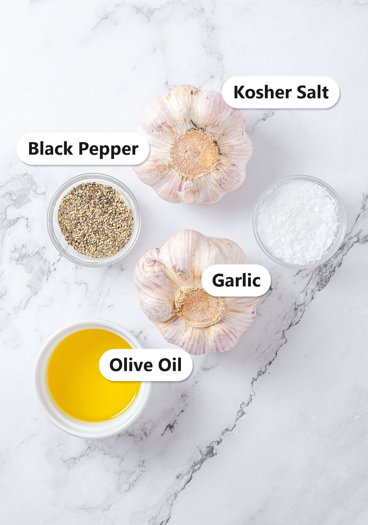 Labeled ingredients for roasted garlic including garlic heads, olive oil, kosher salt, and black pepper.