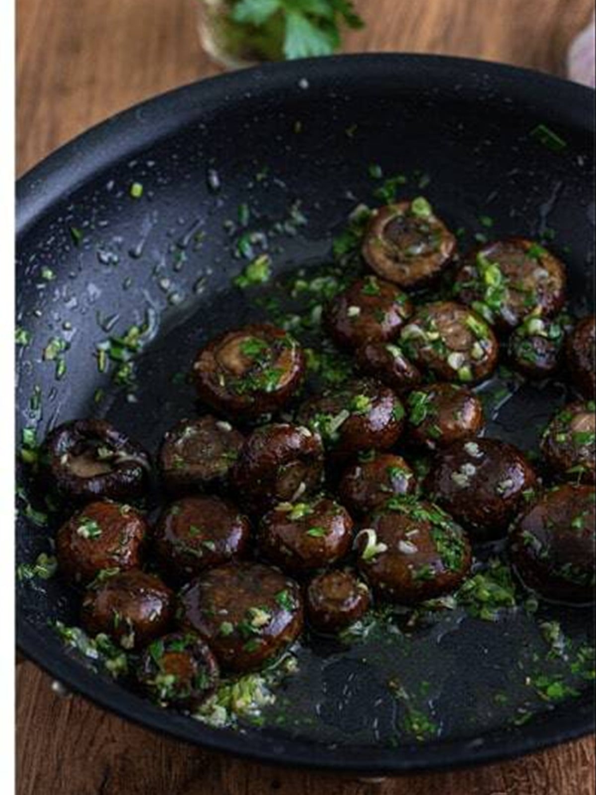 Finished roasted mushrooms in garlic butter sauce with parsley.