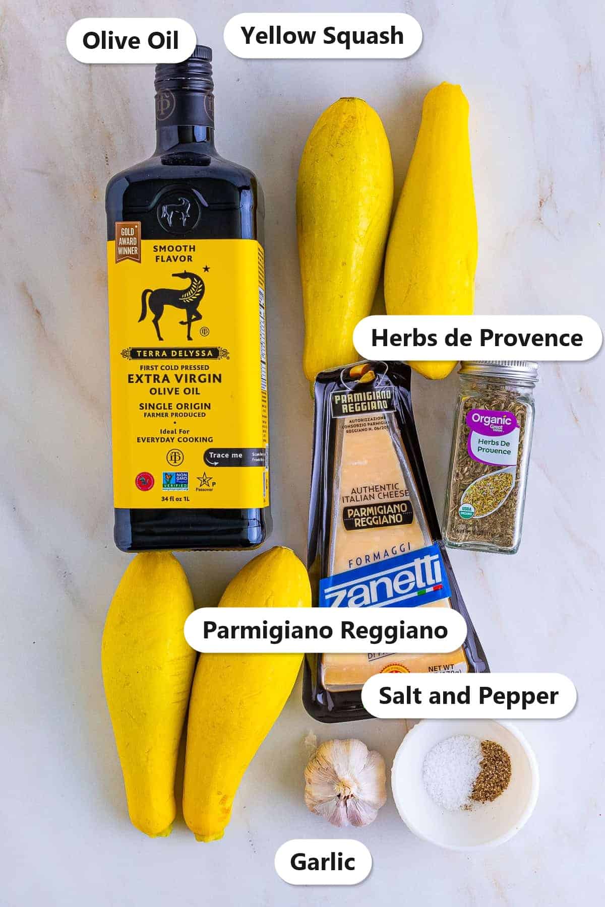 Labeled ingredients for roasted yellow squash including yellow squash, olive oil, Parmigiano Reggiano, herbs de Provence, garlic, and salt and pepper.