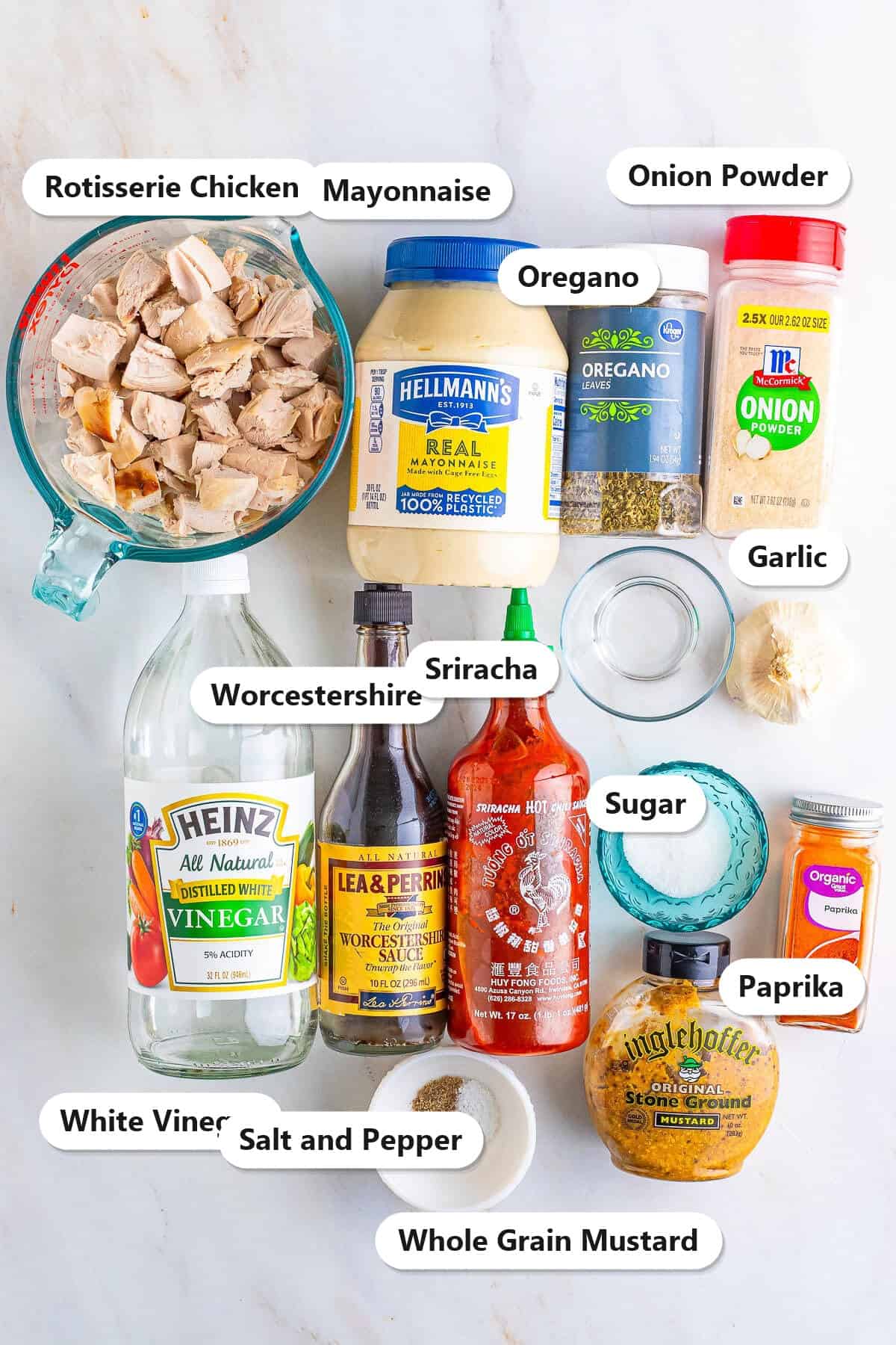 Labeled ingredients for rotisserie chicken salad including diced rotisserie chicken, mayonnaise, vinegar, Worcestershire, sriracha, mustard, and spices.