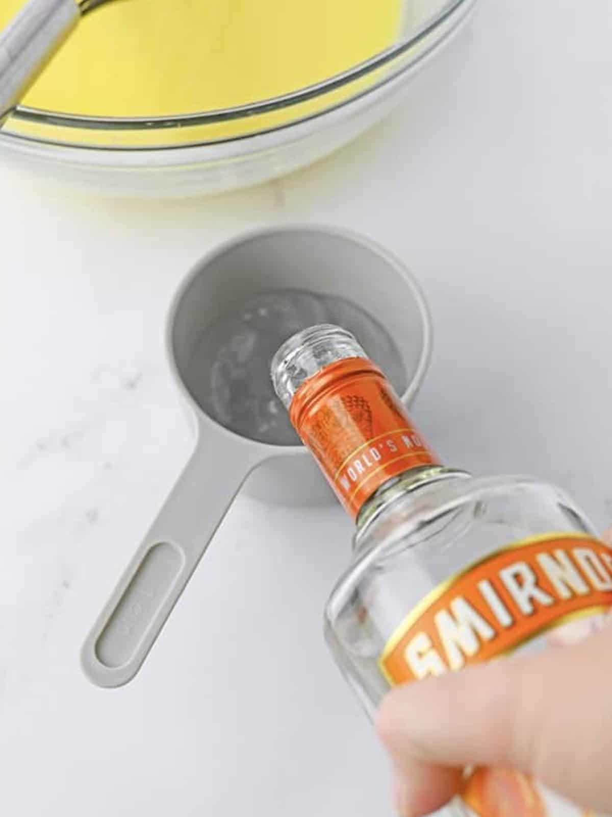 Caramel vodka poured into the pudding mixture for salted caramel pudding shots.
